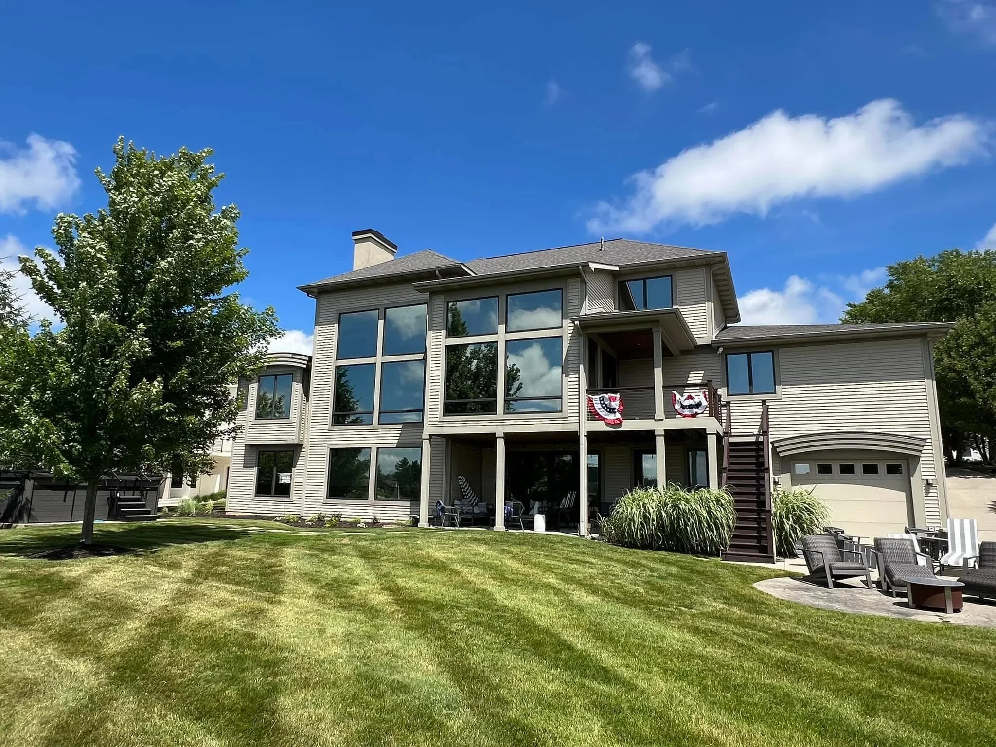 Two-story home with professionally tinted windows on vinyl siding exterior